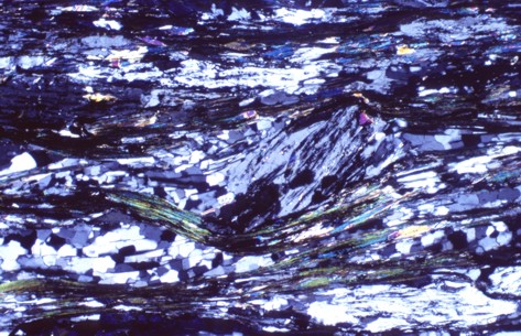 Mylonitic muscovite-chlorite-quartz schist with characteristic plagioclase porphyroblasts in the center